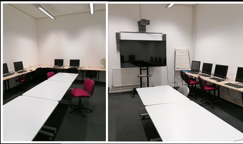 City Library meeting room with tables, chairs, computers and a large TV.